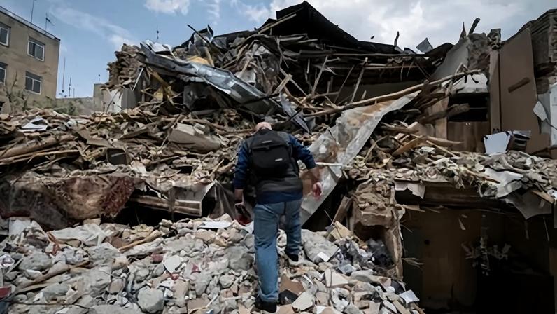 A journalist walks amid the ruins of a synagogue in Tehran last month.