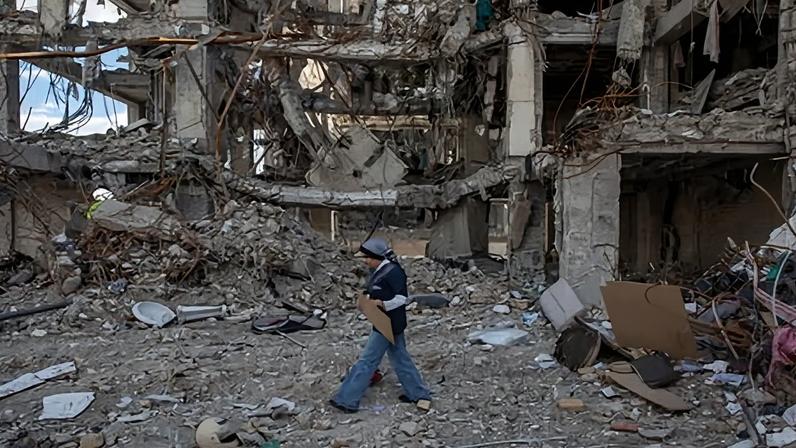 A woman walks among buildings destroyed in a joint attack by Israel and the United States on 6 April 2026 in Tehran, Iran.