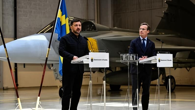 Ukraine’s president, Volodymyr Zelenskyy, stands with the Swedish prime minister, Ulf Kristersson, in front of a Gripen fighter at Uppsala, Sweden.