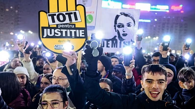 A placard reading ‘all for justice’ is held up during a protest at the Romanian government headquarters in Bucharest in December.