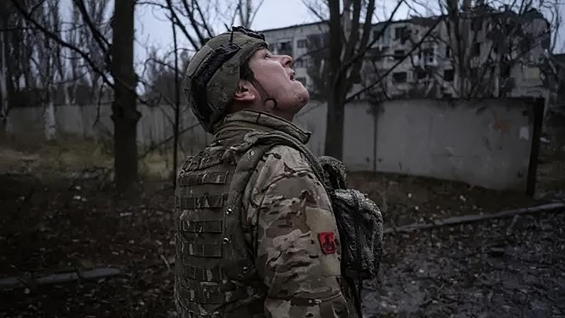 A member of the 93rd brigade checks the sky for drones in the frontline town of Kostyantynivka