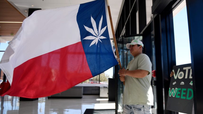 Ariya Lopez carries a Texas flag with a marijuana leaf as the star while members of the Freedom Act Lubbock movement deliver petition signatures to the Lubbock city secretary, Tuesday, Oct. 17, 2023, at Citizens Tower.