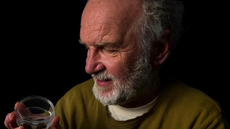 Ian Hughes with two glutinous snails in their last remaining UK habitat, Llyn Tegid in Wales.
