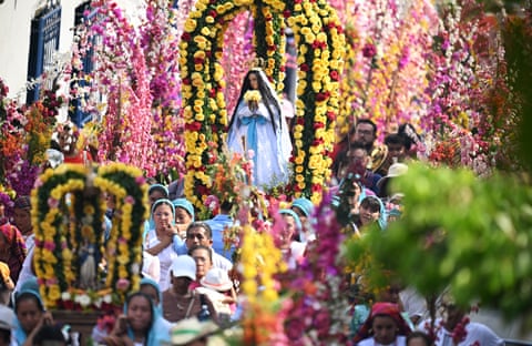 A procession to mark the Brotherhood of Flowers and Palms, a celebration that mixes Catholic practices with indigenous beliefs, in Panchimalco, El Salvador Photograph: Marvin Recinos/AFP/Getty Images