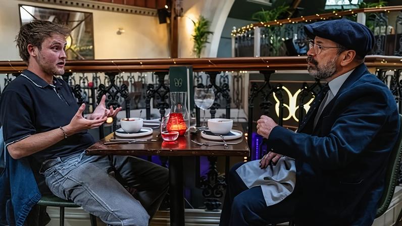 Joe and Eddie chatting at a restaurant table