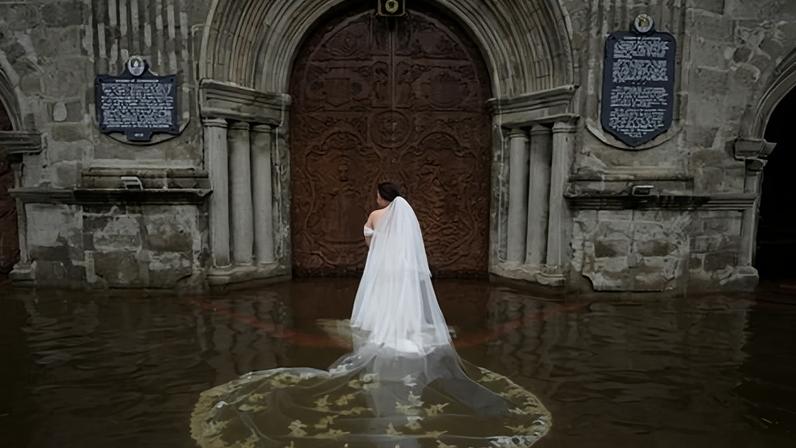 ‘All that lace was never meant to be in water’ … the bride reaches the church with her dress afloat.