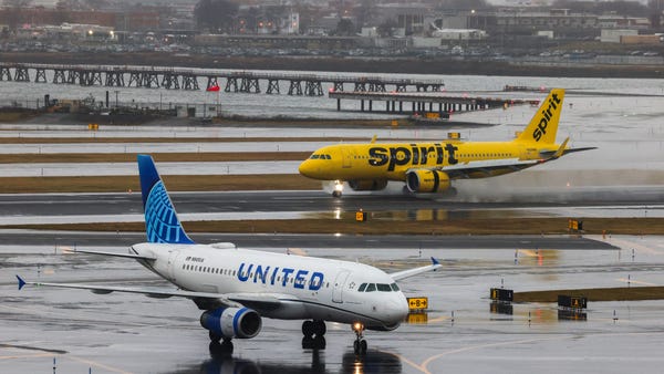 An Airbus A320 passengers aircraft of Spirit airlines arriving from Miami is pictured while an Airbus A319 of United airlines arrived from Denver are seen at LaGuardia Airport on January 9, 2024
