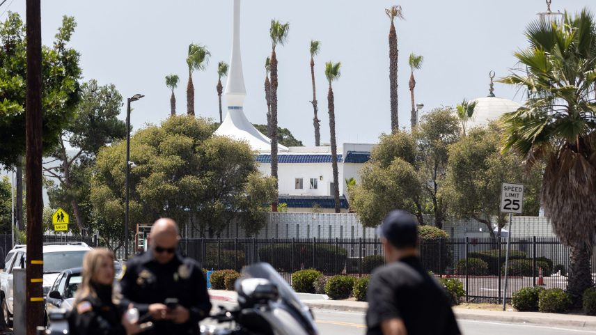 San Diego Police officers stand block the road to the Islamic Center of San Diego following a shooting in Southern California on May 18, 2026. A shooting at the largest mosque complex in San Diego killed three people, with two suspected teenage gunmen later found dead in a car from self-inflicted gunshot wounds, police said.