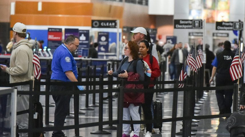 Travelers make their way through a security line at Boston Logan International Airport in Boston on Nov. 10, 2025.
