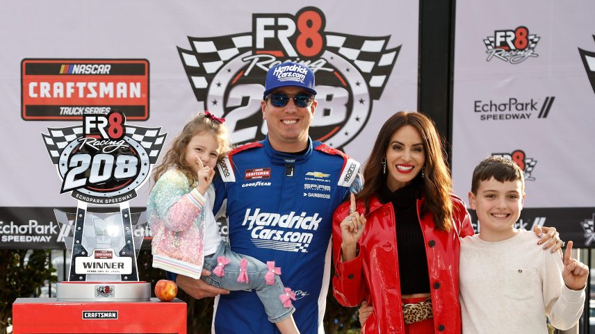 Kyle Busch, driver of the #7 HendrickCars.com Chevrolet, celebrates with daughter Lennix, son Brexton and wife Samantha, in victory lane after winning the NASCAR Craftsman Truck Series Fr8 Racing 208 at Echo Park Speedway on February 21, 2026 in Hampton, Georgia.