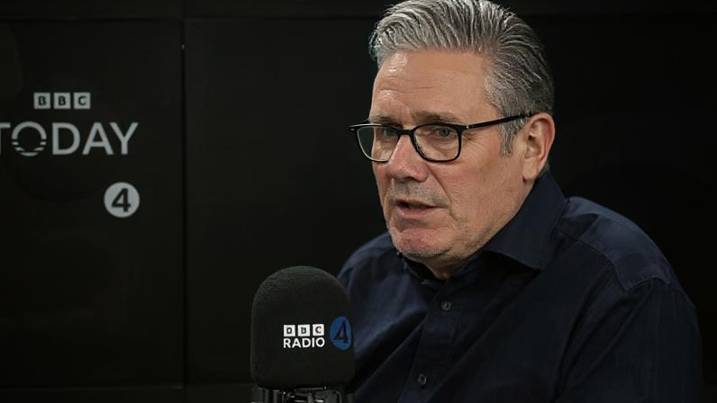 BBC Sir Keir Starmer speaking into a radio microphone in front of a BBC Radio 4 backdrop.