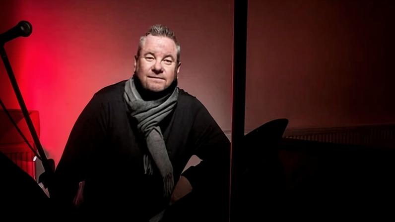 Tony Mortimer in. dimly lit recording studio