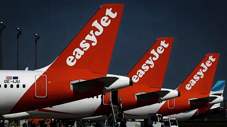 Reuters Three tail fins of EasyJet planes lined up at an airport