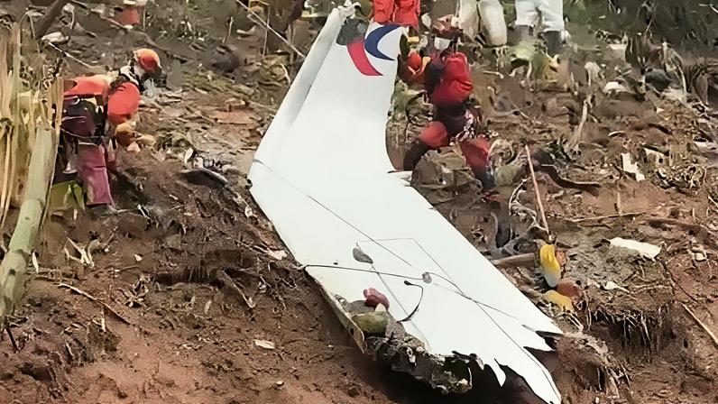 Rescue teams with a piece of the fuselage of China Eastern passenger jet