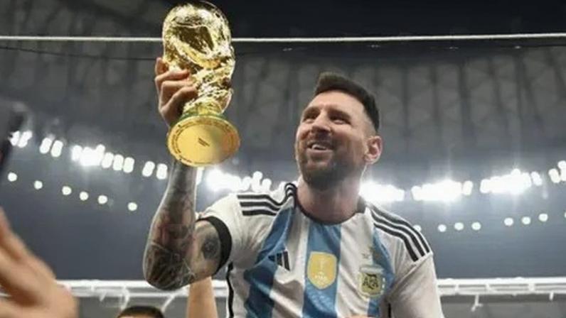 FIFA via Getty Images Argentina's Lionel Messi holding the World Cup trophy