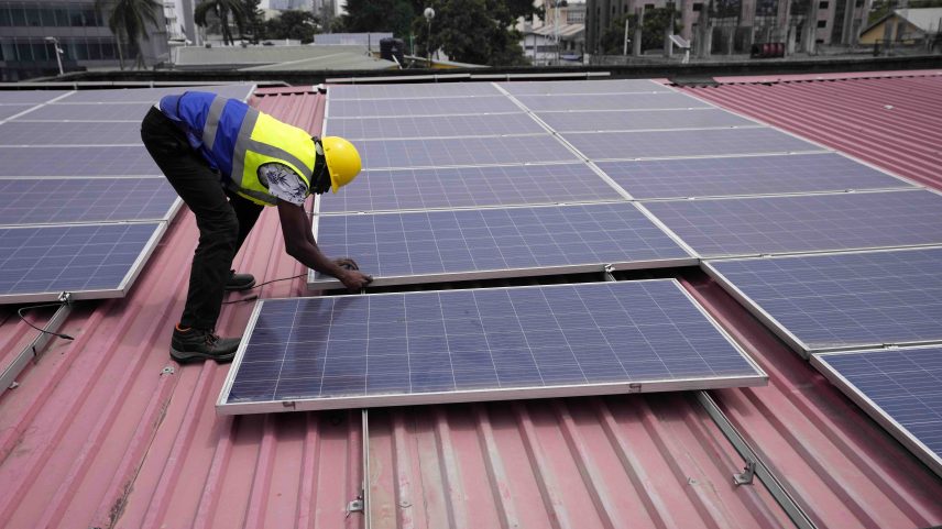 Solar panels being installed on a roof of a house in Lagos, Nigeria. Image by Sunday Alamba/AP Photo.