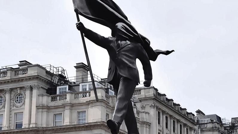 Na imagem, a obra de Banksy, um homem de terno descendo de um pedestal