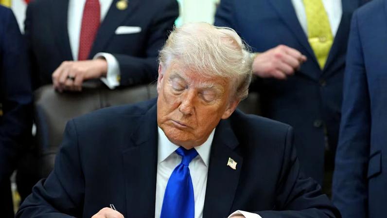 O presidente dos Estados Unidos, Donald Trump, assina uma ordem executiva no Salão Oval, em Washington