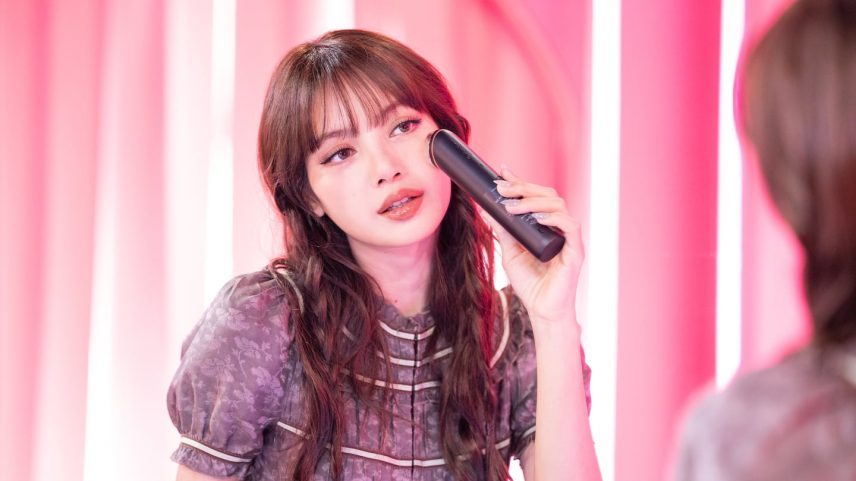 K-pop star Lisa poses with a Medicube device at the brand's 2026 Coachella activation.