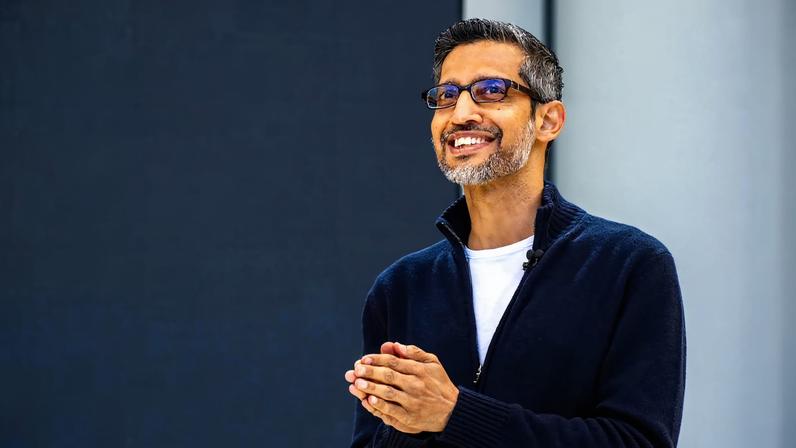 Sundar Pichai smiling with his hands cupped together