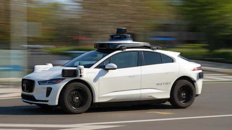 Waymo car in motion on a the street in daylight