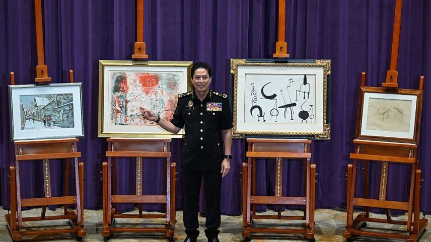 Azam Baki, Malaysia's Anti-Corruption Commission chief commissioner, with artworks by (left to right) Maurice Utrillo, Pablo Picasso, Joan Miro, and Balthus.