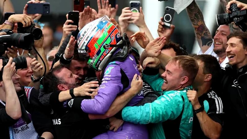 Kimi Antonelli celebrates with his Mercedes team after the race