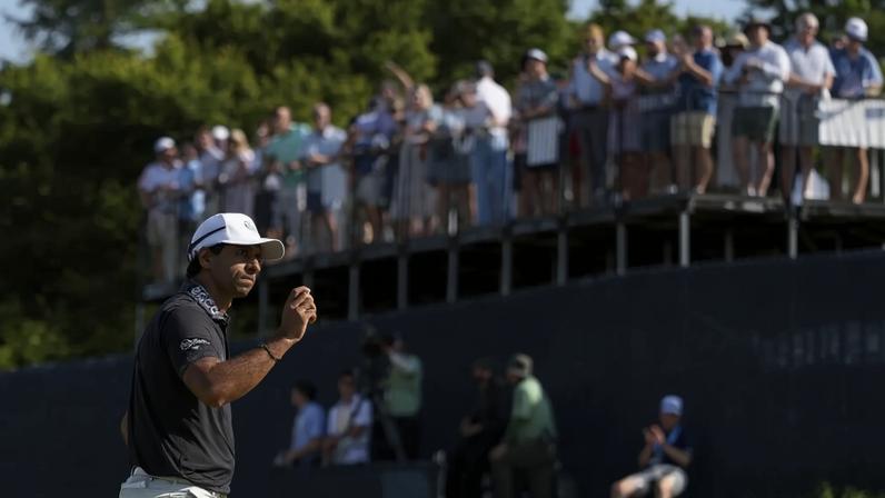 Aaron Rai acknowledges the crowd on the 13th green after a birdie that helped him win the PGA Championship.