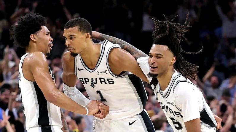 Victor Wembanyama celebrates with Spurs teammates after a half-court shot before the second-quarter buzzer. The Spurs went on to an easy Game 4 win against the Oklahoma City Thunder.
