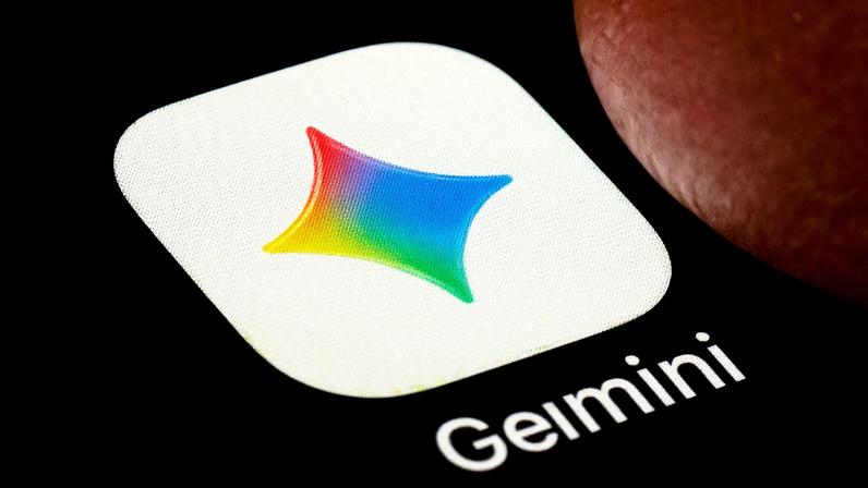 A macro closeup photograph shows the Google Gemini AI application icon on a smartphone screen set against a dark background.