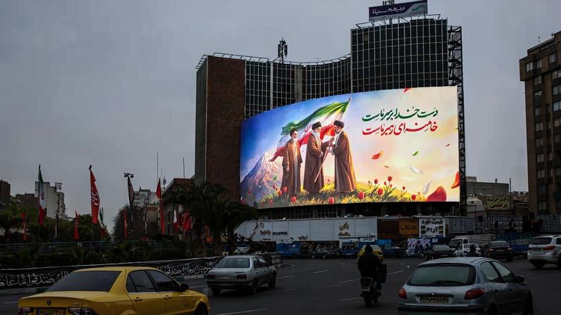 Um outdoor que mostra os três líderes supremos, o aiatolá Khomeini, o aiatolá Khamenei e seu filho, Mojtaba Khamenei, na Praça Valaisr, em Teerã, Irã, em 10 de março de 2026