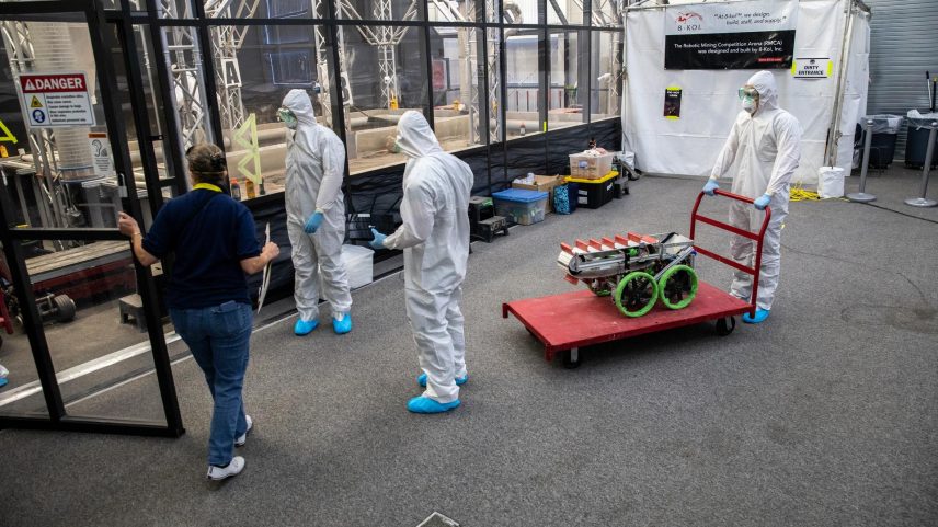 Students from the United States Military Academy (West Point), dressed in safety gear, prepare to enter the mining arena with their robotic miner during NASA’s LUNABOTICS competition on May 24, 2022, at the Center for Space Education near the Kennedy Space Center Visitor Complex in Florida. More than 35 teams from around the U.S. have designed and built remote-controlled robots for the mining competition.