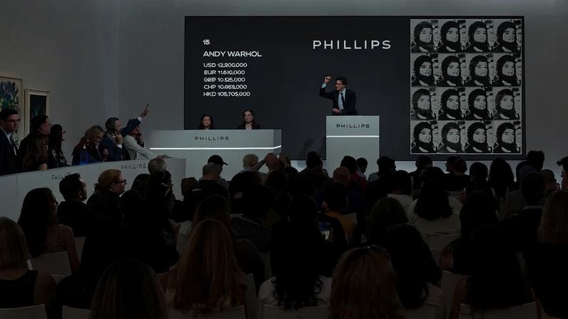 Auctioneer Henry Highley sells Andy Warhol's "Sixteen Jackies," from 1964.