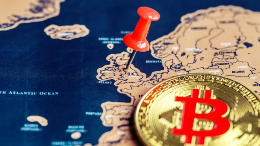 Moeda de Bitcoin sob mapa da Europa- taxinha aponta para Reino Unido -UK
