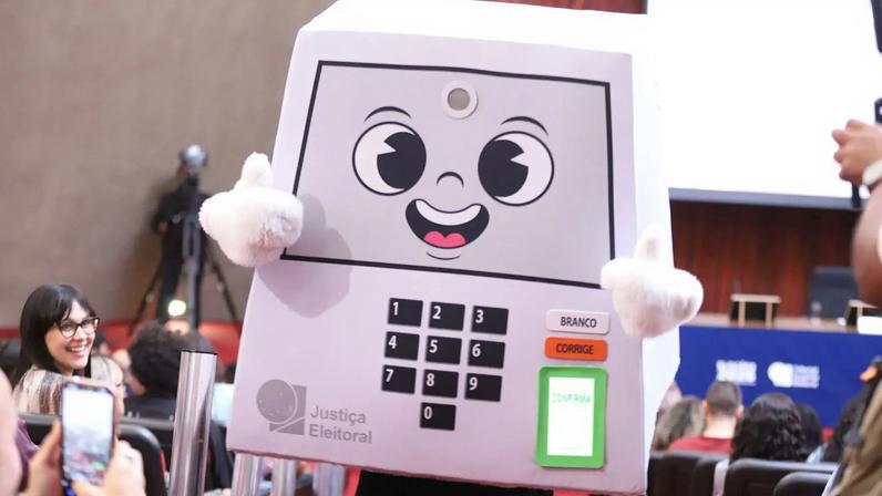 A mascote "Pilili", inspirada na urna eletrônica, foi lançada pelo TSE para ser a "porta-voz da Justiça Eleitoral" nas Eleições 2026. (Foto: Ana Rodrigues / Secom / TSE)