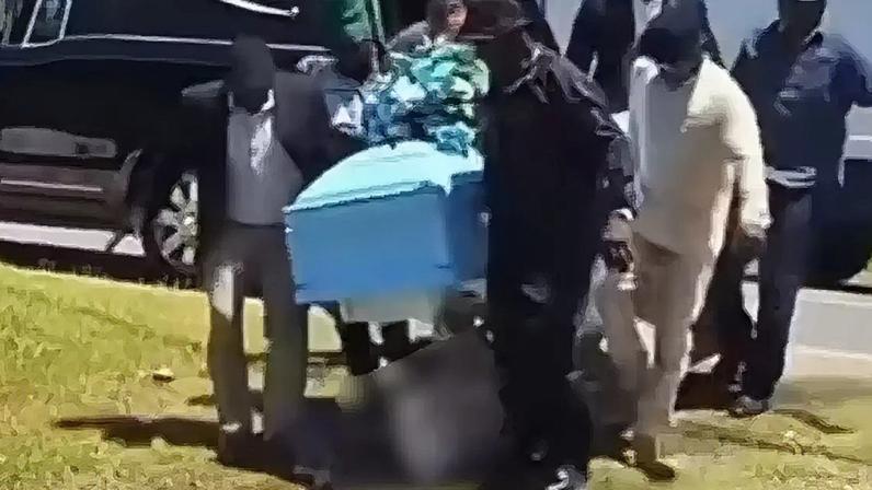 Corpo cai de caixão durante funeral