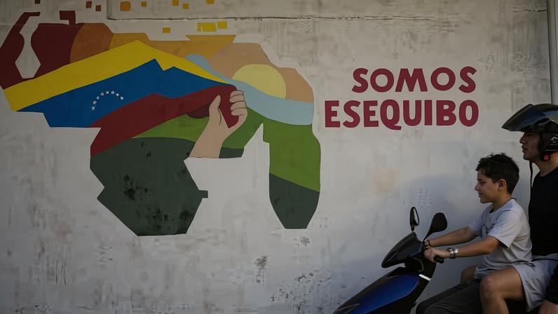 Esequibo - FILE - A boy drives a motorcycle in front of a mural of the Venezuelan map with the Essequibo territory included in the 23 de Enero neighborhood of Caracas, Venezuela, Monday, Dec. 11, 2023. Venezuela