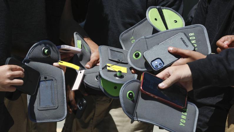 Um aluno usa o celular depois de destravar a bolsa que impede o uso durante o período escolar, na escola Bayside Academy, 16 de agosto de 2024, em San Mateo, Califórnia, EUA. — Foto: Lea Suzuki/San Francisco Chronicle via AP, Arquivo