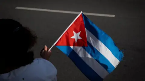 Reuters A woman holds a Cuban flag