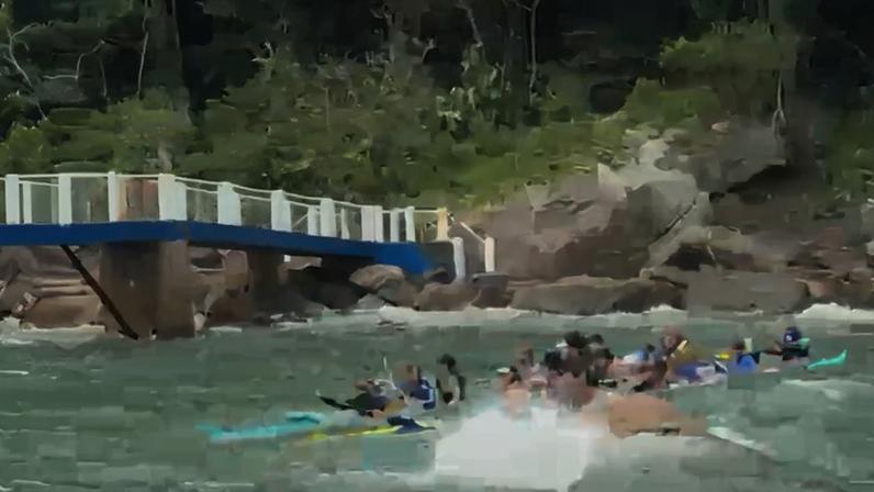 Canoa havaiana é atingida por uma onda em Guarujá. — Foto: Adriano Neris