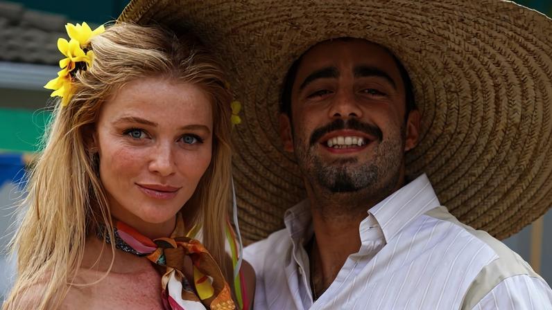 Cintia Dicker aparece ao lado de Pedro Scooby. Ela com uma flor no cabelo e ele de chapéu