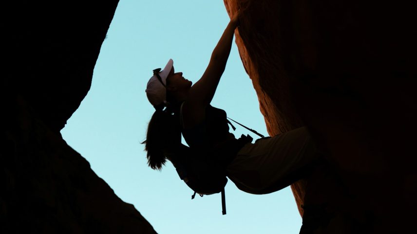 A woman rock climbing.
