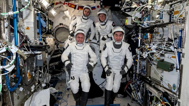NASA’s SpaceX Crew-11 astronauts gather together for a crew portrait wearing their Dragon pressure suits during a suit verification check inside the International Space Station’s Kibo laboratory module. Clockwise from bottom left are, NASA astronaut Mike Fincke, Roscosmos cosmonaut Oleg Platonov, NASA astronaut Zena Cardman, and JAXA (Japan Aerospace Exploration Agency) astronaut Kimiya Yui.
