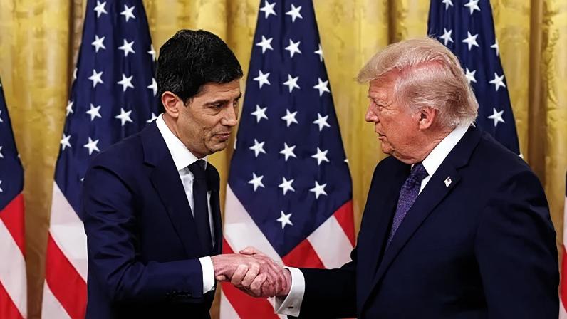 EPA/Shutterstock Donald Trump shakes hands with Kevin Warsh, both men wear navy suits and are flanked by US flags.