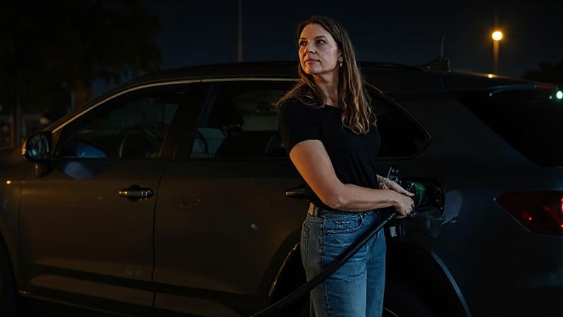 Woman filling up her car with petrol