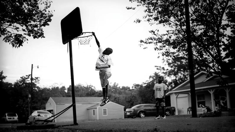 Children play basketball on the street in Joppa, Texas.