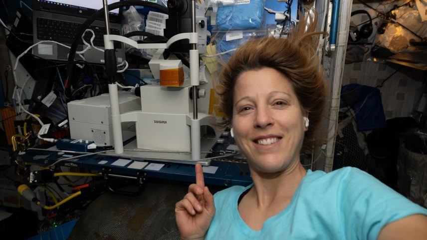 ESA (European Space Agency) astronaut and Expedition 74 flight engineer Sophie Adenot smiles for a portrait while showing off an Optical Coherence Tomography machine, a medical imaging device used for eye exams. Doctors on the ground monitor the eye exam in real-time viewing an astronaut's retina, lens, and cornea.