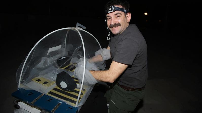 NASA astronaut Jack Hathaway works on MVP Cell-09 research inside a portable glovebag aboard the International Space Station.