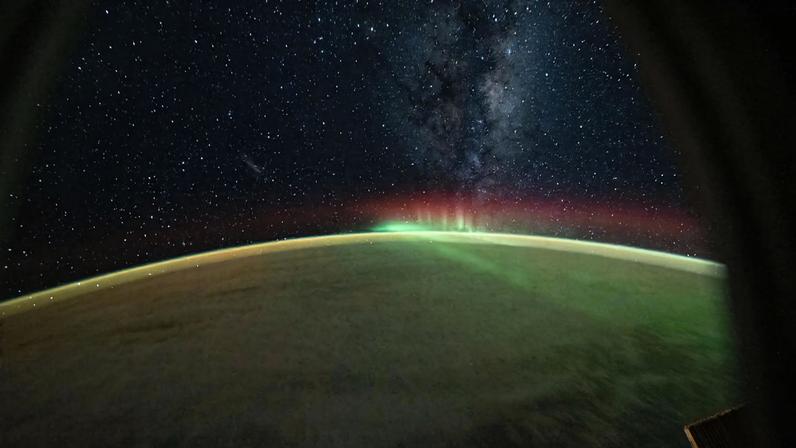 A wispy aurora australis arcs across the Indian Ocean as the Milky Way protrudes above Earth’s atmosphere in this photograph taken at approximately 8:55 p.m. local time from the International Space Station as it orbited 270 miles above the planet.