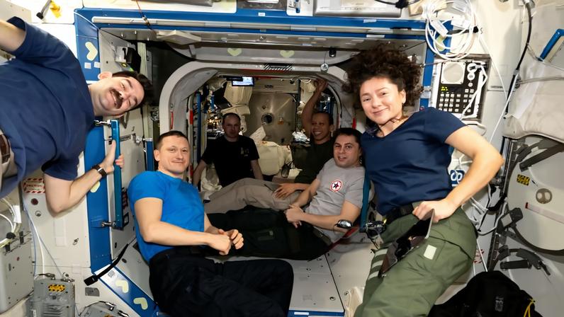Six of the seven Expedition 74 crew members pose for a portrait together aboard the International Space Station. From left are, NASA astronaut Jack Hathaway, Roscosmos cosmonauts Sergey Kud‑Sverchkov and Sergey Mikaev, NASA astronaut Chris Williams, Roscosmos cosmonaut Andrey Fedyaev, and NASA astronaut Jessica Meir. The crew was checking out new hatch‑seal covers that were installed earlier in the day to protect the seals from damage and stains. ESA (European Space Agency) astronaut and Expedition 74 flight engineer Sophie Adenot is out of frame.